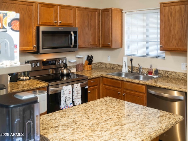455 S Mesa Dr Unit 104, Mesa, AZ 85210 - kitchen featuring stainless steel appliances, a sink, and brown cabinets