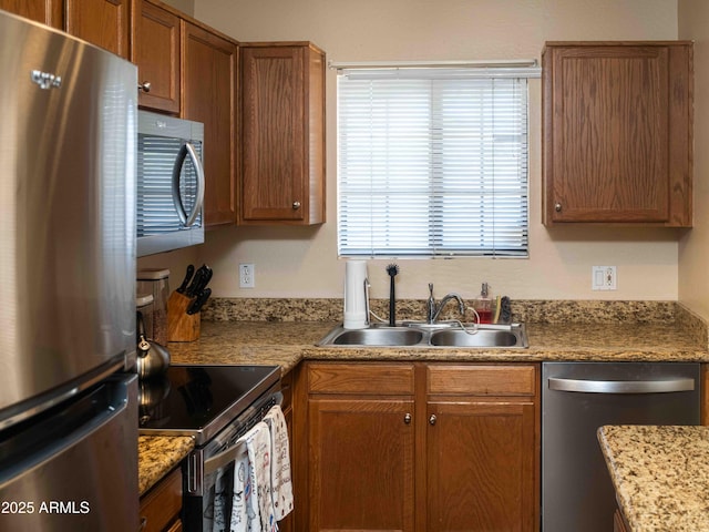 455 S Mesa Dr Unit 104, Mesa, AZ 85210 - kitchen with appliances with stainless steel finishes, a sink, brown cabinetry, and light countertops