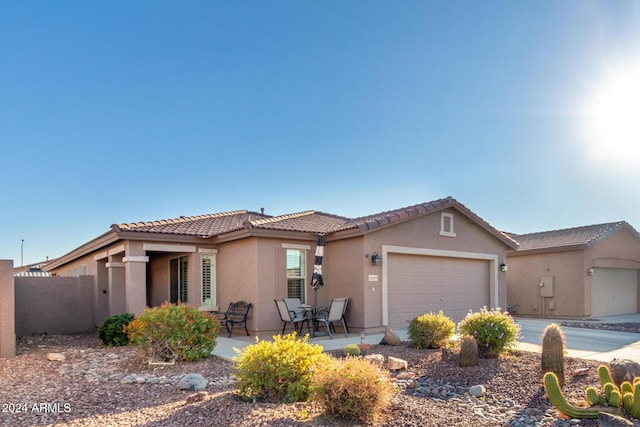 view of front of home featuring a garage and a patio