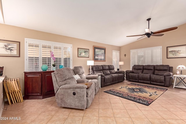 living room featuring ceiling fan, light tile patterned floors, and vaulted ceiling