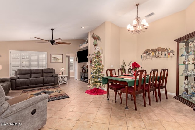 dining room with vaulted ceiling, light tile patterned floors, and ceiling fan with notable chandelier