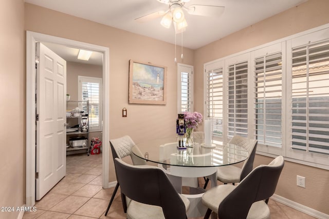 dining area with ceiling fan and light tile patterned floors