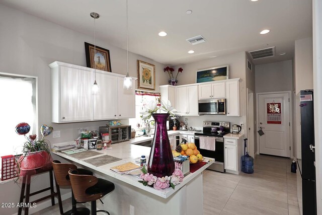 16705 E Almont Dr Unit A, Fountain Hills, AZ 85268 - kitchen with visible vents, stainless steel appliances, light countertops, and a peninsula