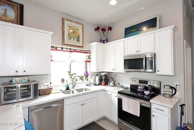 16705 E Almont Dr Unit A, Fountain Hills, AZ 85268 - kitchen featuring light countertops, a sink, appliances with stainless steel finishes, and white cabinetry
