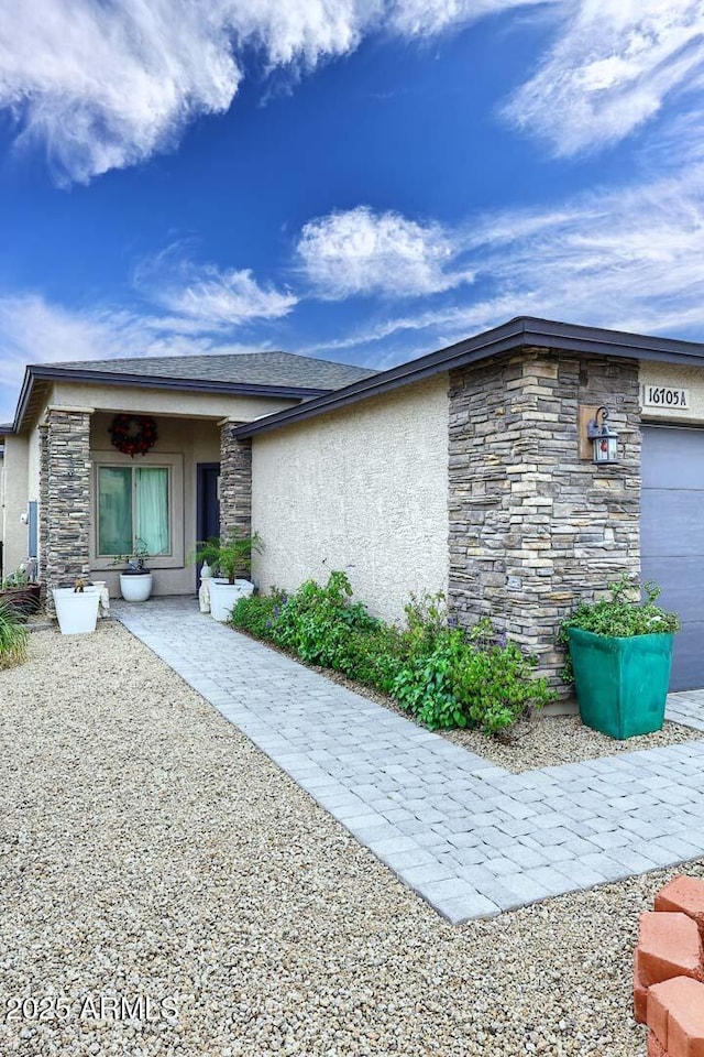 16705 E Almont Dr Unit A, Fountain Hills, AZ 85268 - exterior space with stucco siding, an attached garage, and stone siding
