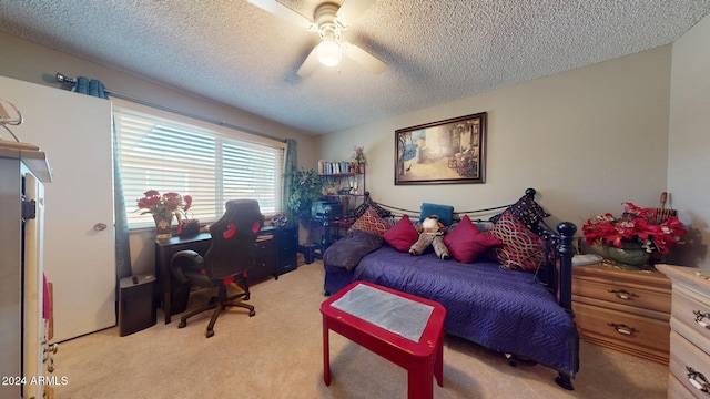 carpeted bedroom featuring a textured ceiling and ceiling fan