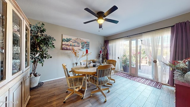 dining space with wood-type flooring and ceiling fan