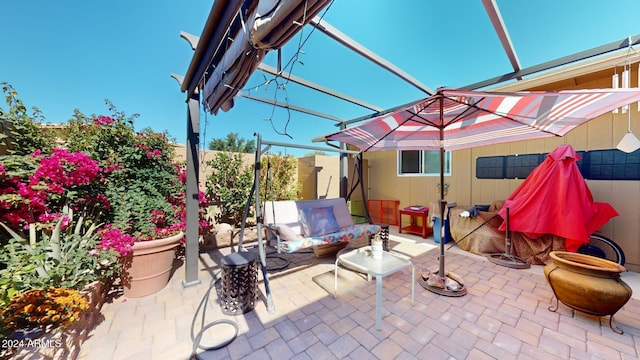 view of patio / terrace with glass enclosure and an outdoor living space