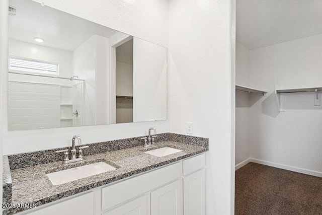 8474 W Clemente Way, Florence, AZ 85132 - full bathroom featuring a spacious closet, double vanity, and baseboards