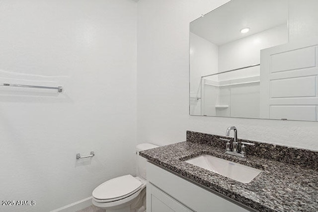 8474 W Clemente Way, Florence, AZ 85132 - bathroom with toilet, vanity, and baseboards