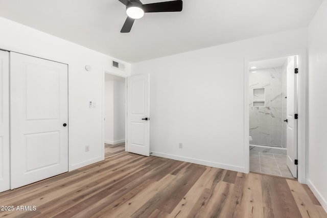 unfurnished bedroom with baseboards, visible vents, connected bathroom, and light wood finished floors