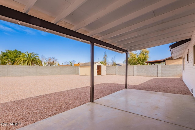 view of patio / terrace with an outdoor structure and a fenced backyard