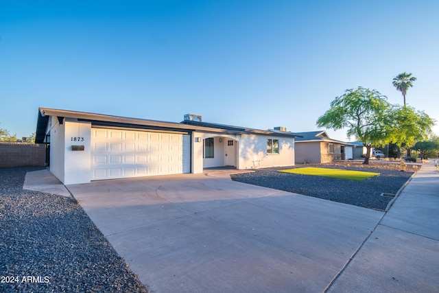 single story home with a front yard and a garage