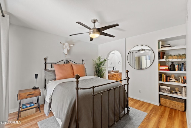 bedroom with light wood-style flooring, baseboards, and ceiling fan