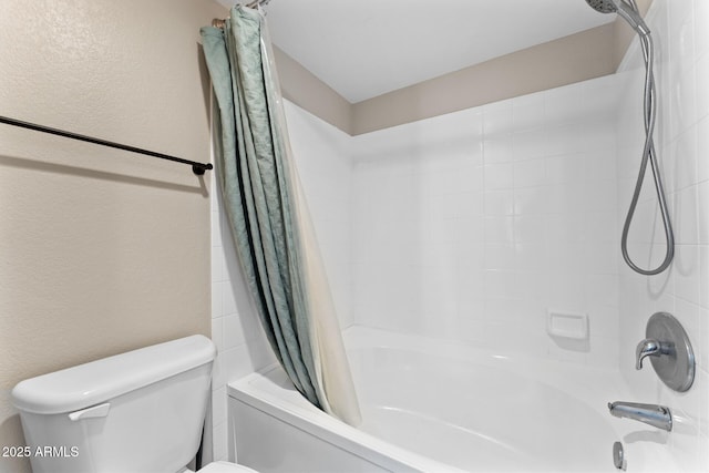 bathroom featuring toilet, shower / tub combo, and a textured wall