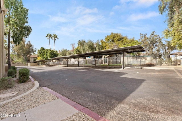 view of parking with fence