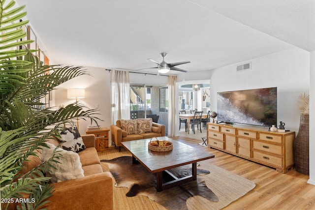 living area featuring ceiling fan, light wood-style flooring, and visible vents