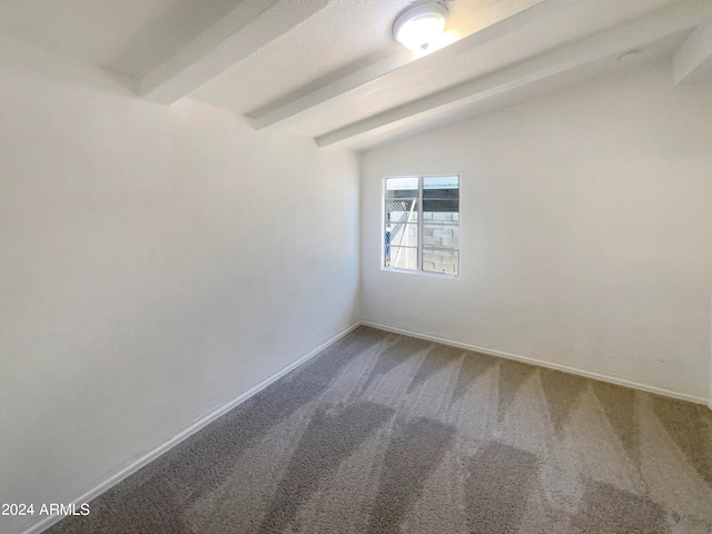 carpeted spare room with lofted ceiling with beams