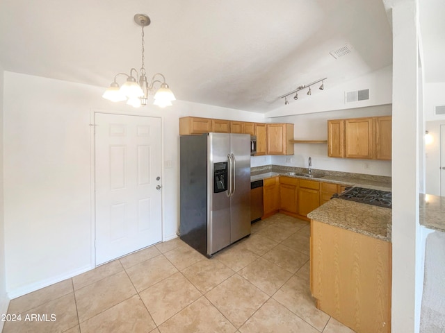 kitchen featuring sink, hanging light fixtures, stainless steel appliances, a chandelier, and vaulted ceiling