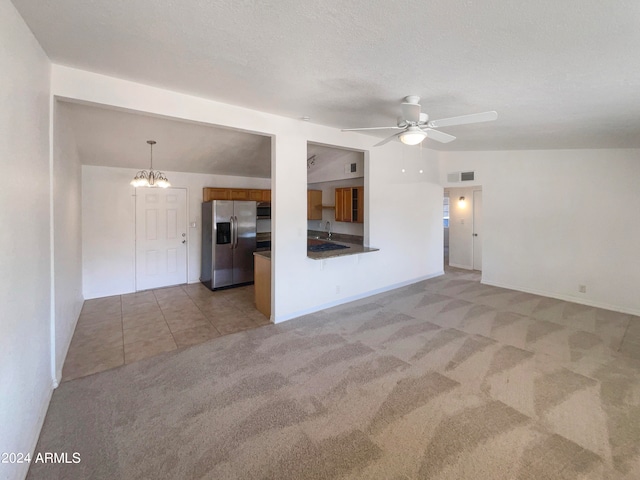 unfurnished living room with a textured ceiling, light colored carpet, ceiling fan, sink, and lofted ceiling