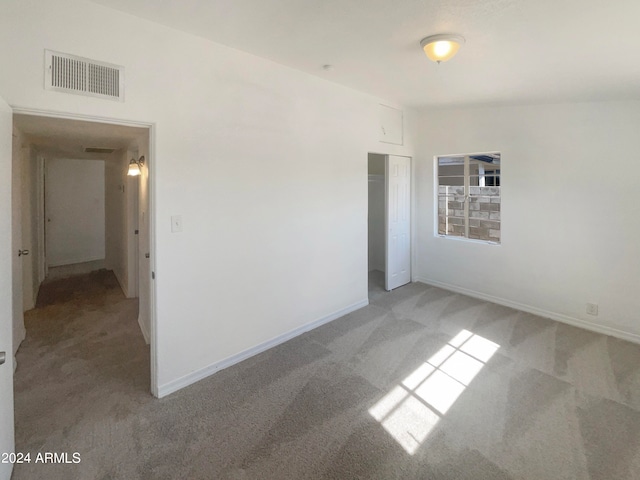 spare room with light colored carpet