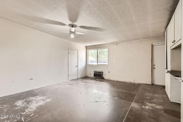 736 E Loyola Dr, Tempe, AZ 85282 - empty room with ceiling fan, unfinished concrete flooring, and a wall mounted air conditioner