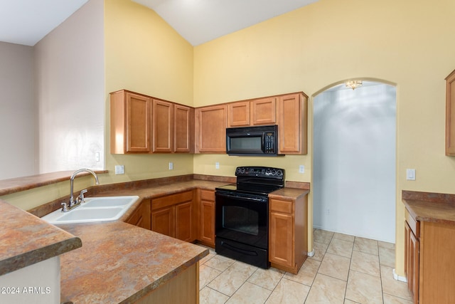 kitchen featuring sink, black appliances, light tile patterned flooring, and kitchen peninsula