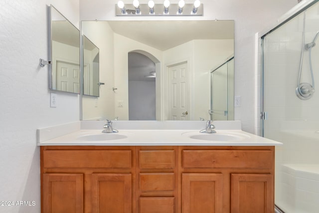 bathroom featuring vanity and an enclosed shower