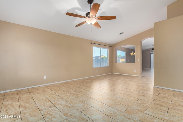 spare room with lofted ceiling and ceiling fan with notable chandelier