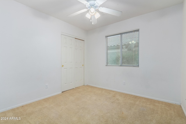 carpeted empty room with ceiling fan