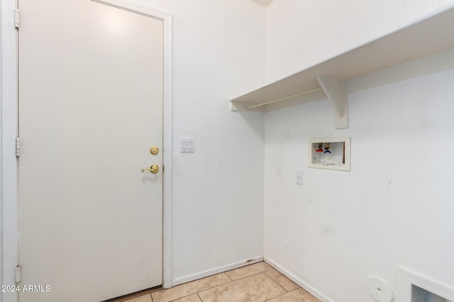 laundry area with washer hookup and light tile patterned floors