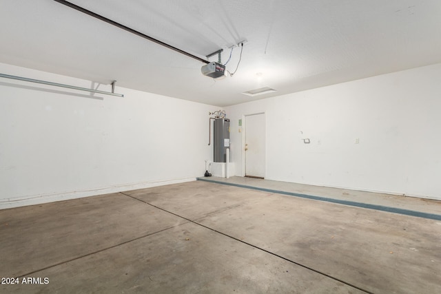 garage with a garage door opener and electric water heater