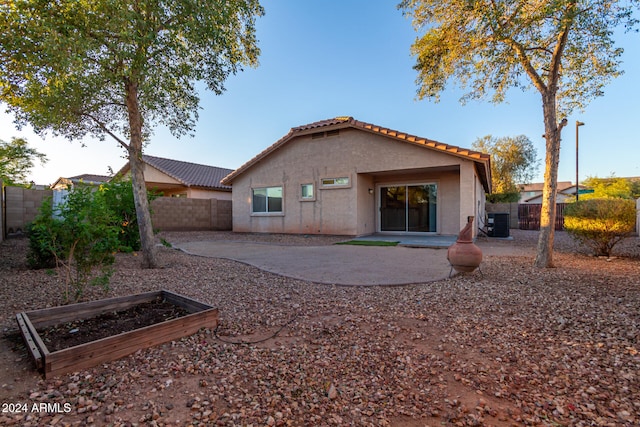 rear view of house featuring a patio and cooling unit