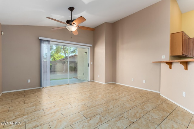 spare room featuring ceiling fan and vaulted ceiling