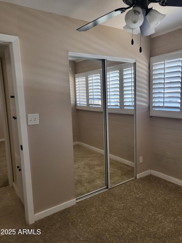815 N Hayden Rd Unit A204, Scottsdale, AZ 85257 - unfurnished bedroom featuring carpet, a closet, and ceiling fan