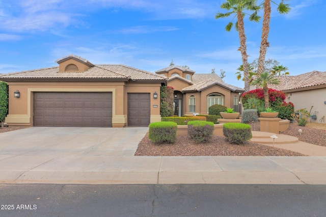 view of front of home featuring concrete driveway, a tiled roof, an attached garage, and stucco siding