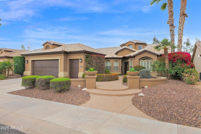 view of front of house featuring stucco siding, concrete driveway, a tile roof, and an attached garage