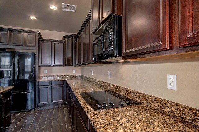 kitchen with black appliances and light stone counters