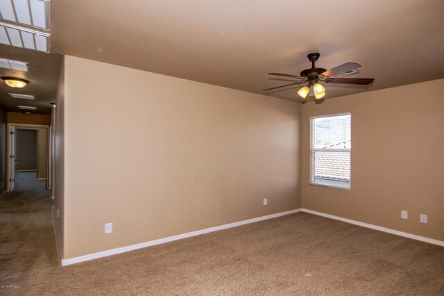 carpeted spare room with ceiling fan