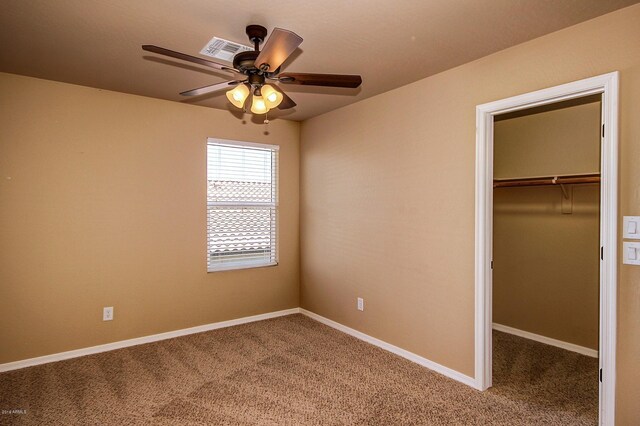 unfurnished bedroom featuring carpet, a closet, and ceiling fan