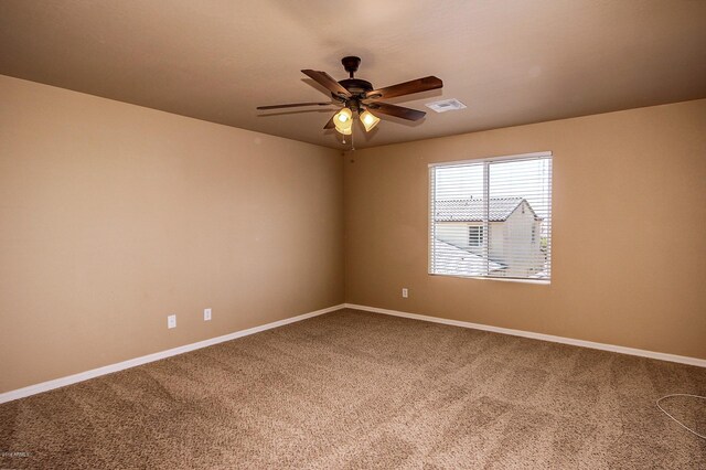 carpeted spare room with ceiling fan