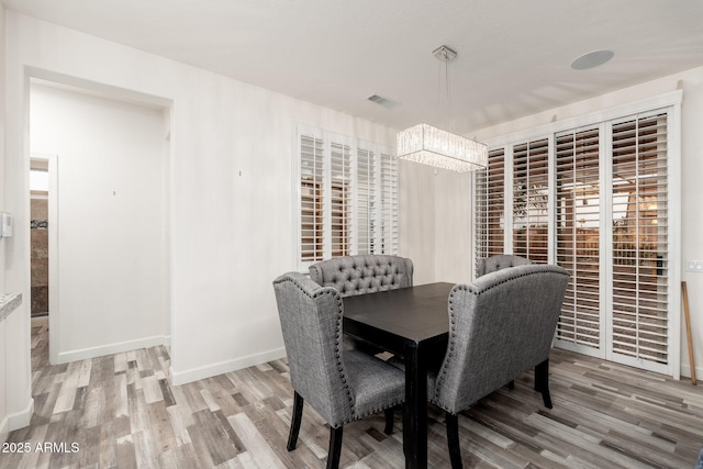 15583 W Big Sky Dr, Surprise, AZ 85374 - dining area featuring hardwood / wood-style flooring and a notable chandelier
