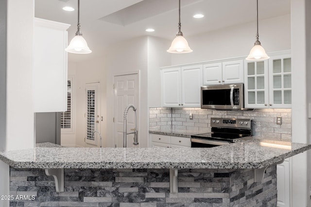 15583 W Big Sky Dr, Surprise, AZ 85374 - kitchen featuring pendant lighting, white cabinets, and appliances with stainless steel finishes