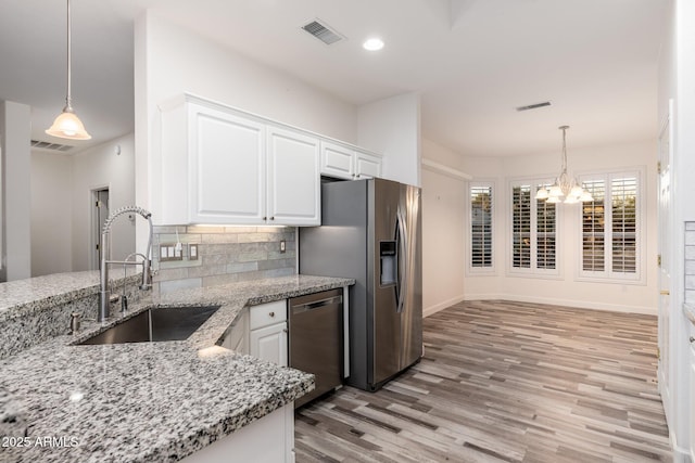 15583 W Big Sky Dr, Surprise, AZ 85374 - kitchen featuring light stone countertops, white cabinetry, appliances with stainless steel finishes, and sink