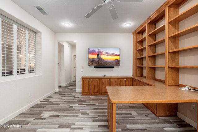 15583 W Big Sky Dr, Surprise, AZ 85374 - unfurnished office featuring built in desk, ceiling fan, and light hardwood / wood-style flooring