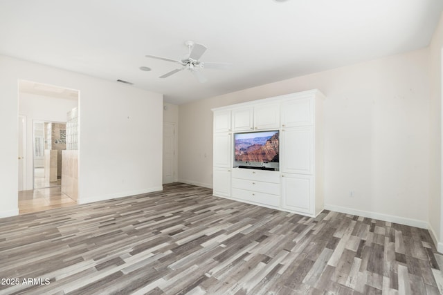 15583 W Big Sky Dr, Surprise, AZ 85374 - unfurnished living room featuring light hardwood / wood-style floors and ceiling fan