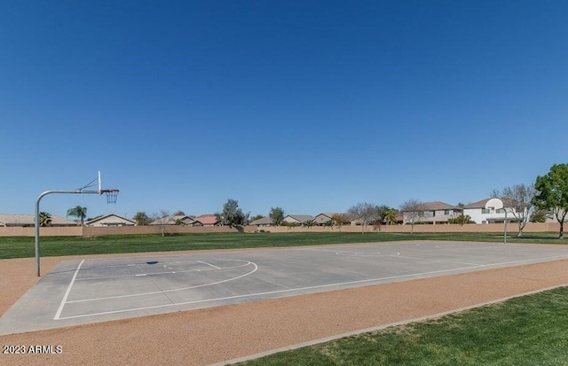 view of basketball court featuring a yard