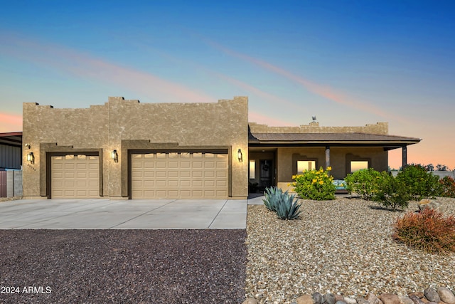 pueblo-style home with a garage