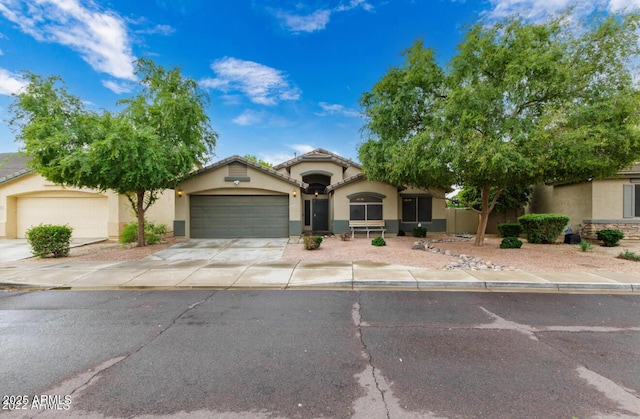 12325 W Berridge Ln, Litchfield Park, AZ 85340 - mediterranean / spanish home featuring a garage, stucco siding, and driveway