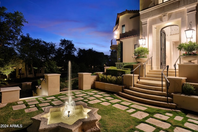 yard at dusk with a balcony